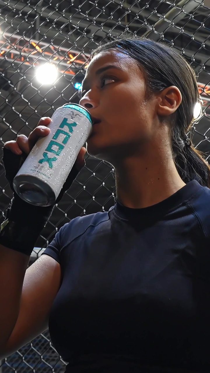 Saarah Karriem drinks KNOX in the cage