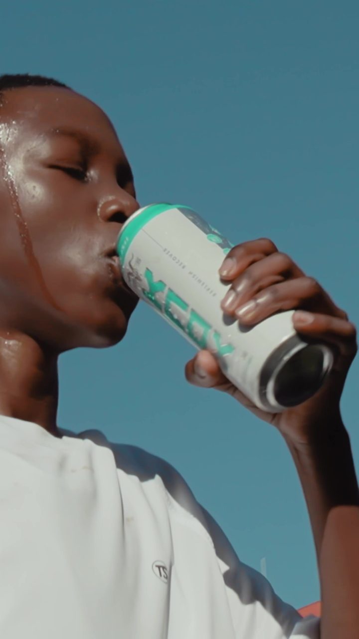 Frame from the film: the player drinks from a KNOX can against the sky