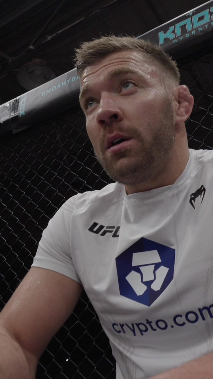 Dricus du Plessis sits against the cage