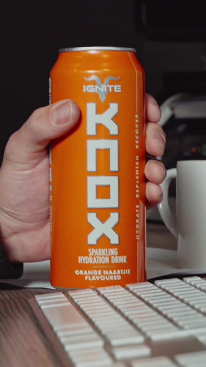 Orange Naartjie KNOX can next to a keyboard