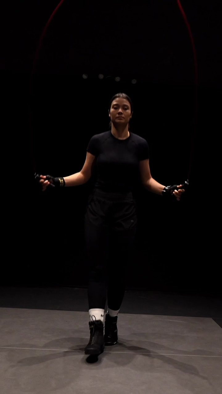 Saarah Karriem skipping under a spotlight