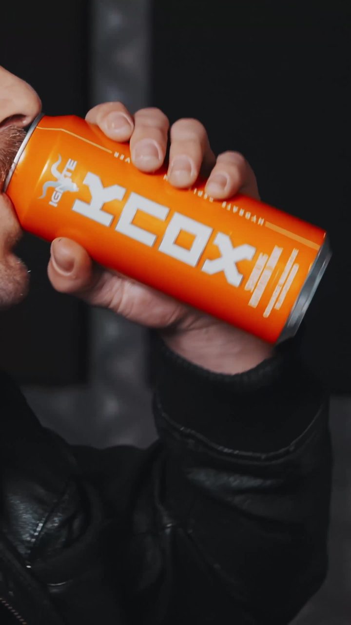 Zaan Sonnekus drinking an orange KNOX can in the studio